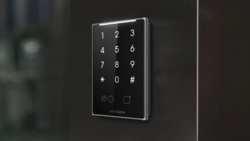 Hikvision access-control reader with a keypad mounted beside a door