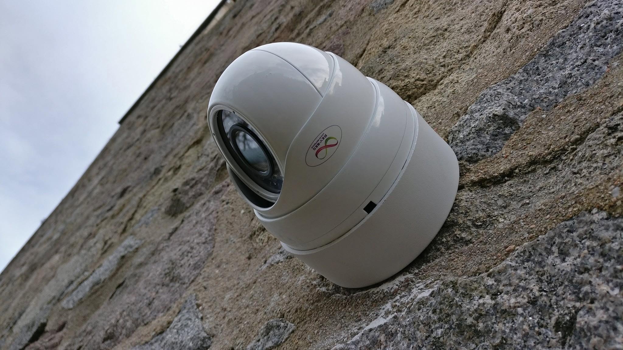 Finished CCTV camera installation mounted neatly on a stone wall